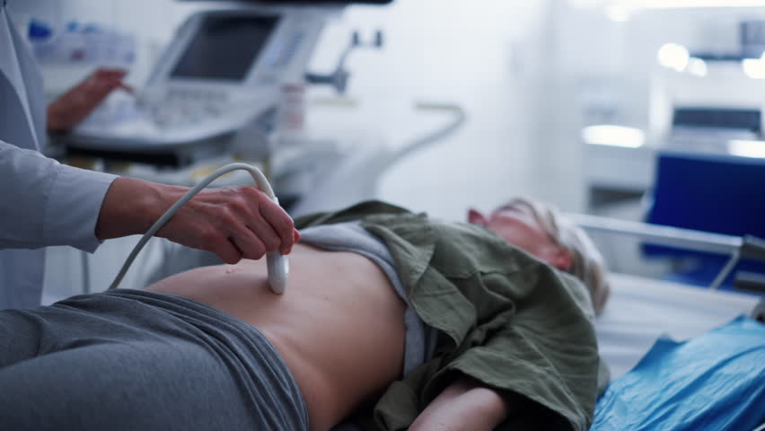 Female patient undergoing abdominal ultrasound screening.