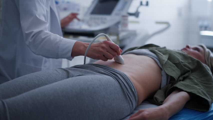Female patient undergoing abdominal ultrasound screening.