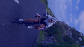 Cyclist riding on coastal road with data visualization animation over landscape. Cycling, outdoors, technology, fitness, active, sport - Powered by Shutterstock - Get 15% off with code: PIKWIZARD15