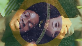 Brazilian flag animation over smiling family lying on beach towels. vacation, leisure, summer, relaxation - Powered by Shutterstock - Get 15% off with code: PIKWIZARD15