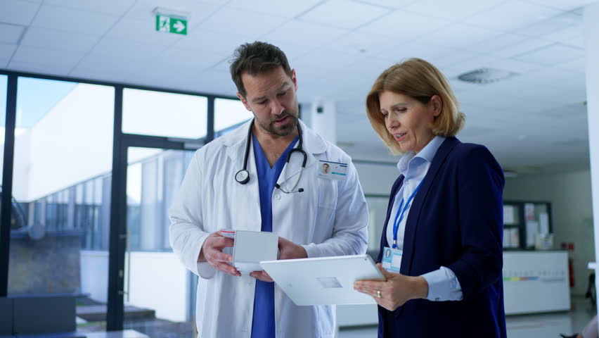 Female medical sales representative presenting medication to doctor