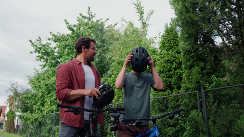 Dad and teenage son during fun cycling trip.