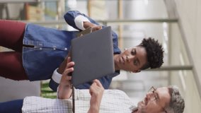 Animation of multiple notification bars over diverse coworkers discussing reports on laptop. Digital composite, multiple exposure, business, planning, teamwork, social media reminder and technology. - Powered by Shutterstock - Get 15% off with code: PIKWIZARD15