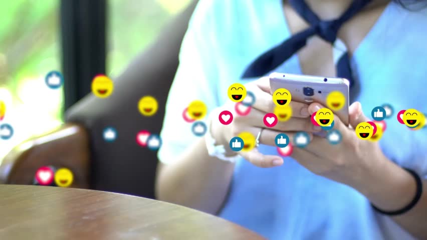 Engaging video of a woman using a smartphone with animated social media icons like hearts, smileys, and thumbs-up floating around. Perfect for content about social media, online engagement.r
