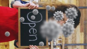 Animation of virus cells over happy caucasian waitress with open sign. business and covid 19 pandemic concept digitally generated video. - Powered by Shutterstock - Get 15% off with code: PIKWIZARD15