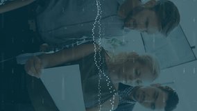 Animation of data processing over diverse team of colleagues reading documents together at office. Global economy and business technology concept - Powered by Shutterstock - Get 15% off with code: PIKWIZARD15