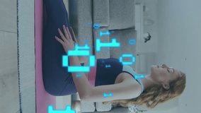 Animation of caucasian woman exercising with laptop and binary coding data processing. Global exercise, fitness, computing, digital interface and data processing concept digitally generated video. - Powered by Shutterstock - Get 15% off with code: PIKWIZARD15