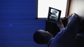 Doctor and X-ray. X-ray. Vertical video. Slow motion. High-quality video recording in 4K format. - Powered by Shutterstock - Get 15% off with code: PIKWIZARD15