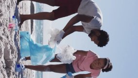 Animation of recycling symbol over african american couple cleaning at beach. Global ecology and digital interface concept digitally generated video. - Powered by Shutterstock - Get 15% off with code: PIKWIZARD15