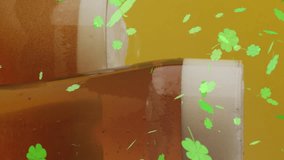 Animation of st patrick's day green shamrock falling over beer glasses. St patrick's day, irish tradition and celebration concept digitally generated video - Powered by Shutterstock - Get 15% off with code: PIKWIZARD15