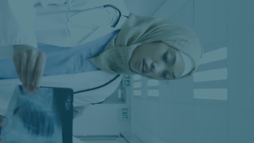 Animation of financial graphs and data over diverse female doctors with x ray photo. health, medical profession, economy, finance and technology concept digitally generated video.