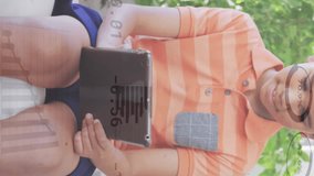 Animation of graphs and currency signs over boy using digital tablet while sitting on sofa. Digital composite, finance, report, business, investment, childhood, technology and home concept. - Powered by Shutterstock - Get 15% off with code: PIKWIZARD15