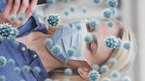 Animation of virus cells over caucasian woman wearing face mask and using smartphone. global covid 19 pandemic and health concept digitally generated video. - Powered by Shutterstock - Get 15% off with code: PIKWIZARD15