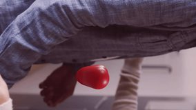 Animation of hearts over diverse couple embracing and smiling at home. Relationships, love, togetherness and lifestyle concept digitally generated video. - Powered by Shutterstock - Get 15% off with code: PIKWIZARD15