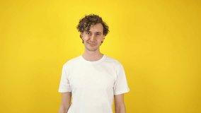 Smiling man asking money gesture on yellow studio background. Smart man smiles slyly, he has idea how earn. Profitable investments, stock market game, cryptocurrency mining. Thanks. World Savings Day - Powered by Shutterstock - Get 15% off with code: PIKWIZARD15