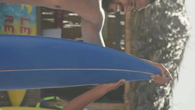 Animation of red heart love emojis digital icons over men holding surfboard on beach. digital interface, social media and global networking concept digitally generated video. - Powered by Shutterstock - Get 15% off with code: PIKWIZARD15