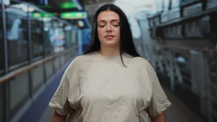 Woman meditating on cruise ship deck, eyes closed, in peaceful surroundings, expressing calm and contemplation during outdoor voyage.