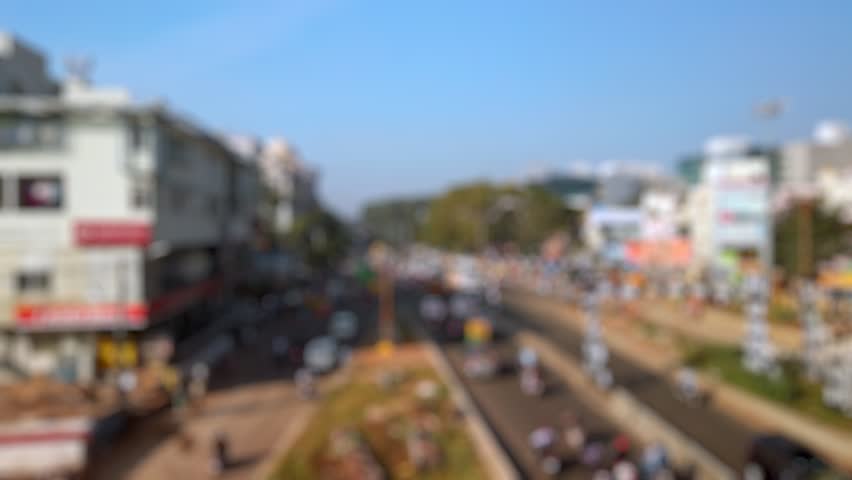 Bokeh view of road traffic on the streets of Bangalore, India. Blurred background footage.