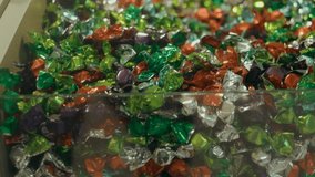 Macro view of multi-colored wrapped candies in metallic foil, featuring green, orange, red, silver, and purple. The treats are densely arranged, reflecting light and creating a festive, vibran - Powered by Shutterstock - Get 15% off with code: PIKWIZARD15