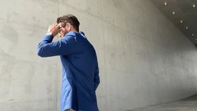 Successful handsome businessman wearing blue suit and sunglasses checking time and look far - Powered by Shutterstock - Get 15% off with code: PIKWIZARD15