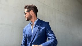 Successful handsome businessman wearing blue suit and sunglasses checking time and look far - Powered by Shutterstock - Get 15% off with code: PIKWIZARD15