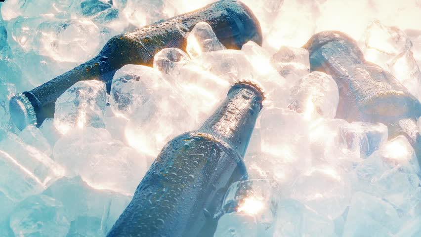 Bottles Of Beer Rotating On Ice in Cold Vapor