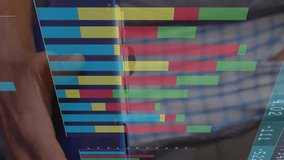 Animation of multiple graphs and numbers charts over caucasian man writing in notepad at warehouse. Digital composite, multiple exposure, report, business, inventory and distribution concept. - Powered by Shutterstock - Get 15% off with code: PIKWIZARD15