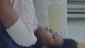 Animation of eco icons and data processing over african american woman reading book on sofa at home. Global green energy, connections, computing and data processing concept digitally generated video. - Powered by Shutterstock - Get 15% off with code: PIKWIZARD15