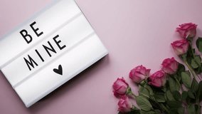  A romantic Valentine's Day animation featuring pink roses, a "Be Mine" message, and festive confetti explosion on a table.  - Powered by Shutterstock - Get 15% off with code: PIKWIZARD15