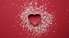 A romantic Valentine's Day animation featuring heart-shaped confetti exploding on a table.  - Powered by Shutterstock - Get 15% off with code: PIKWIZARD15