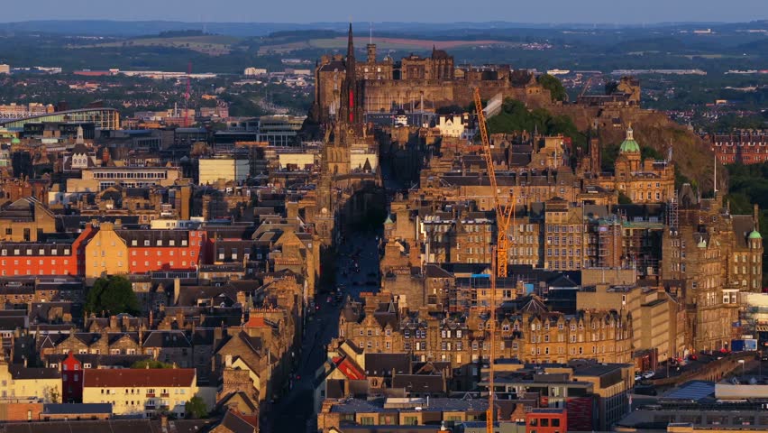 Edinburgh, Scotland, United Kingdom. July 11, 2025. Aerial view of Edinburgh showcasing the historic Royal Mile, Edinburgh Castle, and surrounding architecture at Sunrise