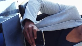 Animation of connected icons globes over man scrolling on smartphone at office. Digital composite, multiple exposure, communication, globalization and technology concept. - Powered by Shutterstock - Get 15% off with code: PIKWIZARD15