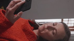 Animation of social media icons over caucasian senior woman sneezing while using smartphone at home. Social media networking technology concept - Powered by Shutterstock - Get 15% off with code: PIKWIZARD15