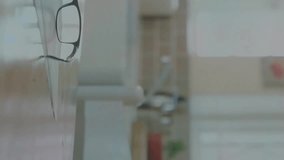 Animation of network of connections with icons over empty office with laptop. Technology, business and digital interface concept digitally generated video. - Powered by Shutterstock - Get 15% off with code: PIKWIZARD15