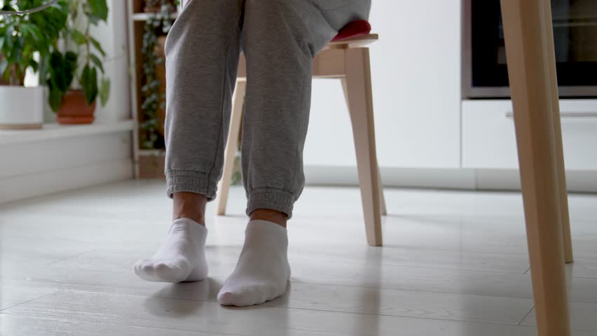 Restless feet tapping nervously legs scraping chair twitching involuntarily. ADHD symptoms, hyperactive stim, leg cramps or muscular spasm physical tension, hyperactive traits, stress response