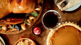 A thanksgiving dinner table is set with turkey and pie - Powered by Shutterstock - Get 15% off with code: PIKWIZARD15