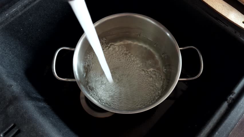 Running Water Filling Stainless Steel Pot In Kitchen Sink. Cooking Preparation And Culinary Process. Kitchen Utensils Dinner Preparation. Recipe Steps Water For Pasta. Simple Living Mealtime Prep