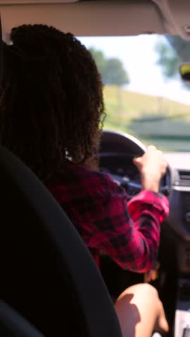 Woman driving car on sunny day with passenger's changing point of view, showcasing scenic countryside and journey's sense of freedom