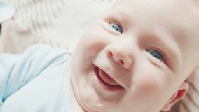 Portrait of the newborn boy (5 months old) with deep blue eyes in the bright white room - Powered by Shutterstock - Get 15% off with code: PIKWIZARD15