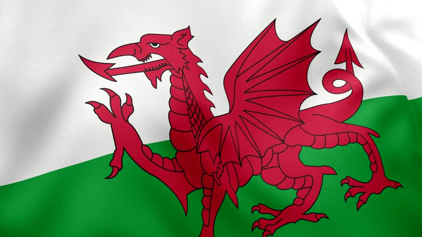 Realistic Wales flag gently waving in the wind on a clear sky background. Ideal 4K loop animation for patriotic visuals, national celebrations, or global presentations.