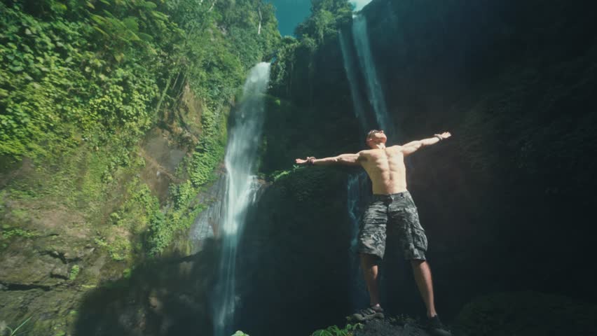 Travel people explore famous hidden gems North Bali Sekumpul Waterfall, the highest and most beautiful waterfall Bali, Indonesia 4K