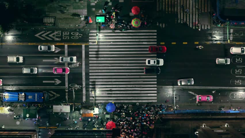 Crowded crosswalk on Eje Central in Mexico City at night, aerial view
