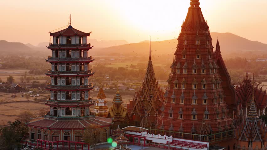 Aerial view of Wat tham sua, a buddhist temple on a hill near rice fields in Kanchanaburi, Thailand
