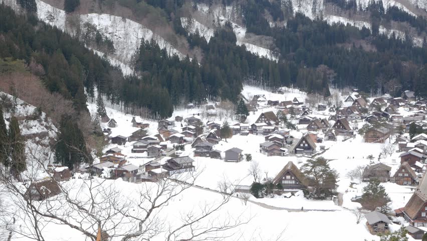 aerial landscape view of shirakawago village among mountain hill range with many gassho zukuri traditional house japanese style with snow covered. Shirakawago village in winter snowy time