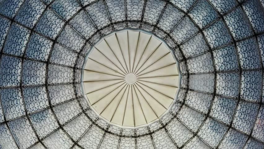 Stunning top view of dome-shaped glass ceiling with a symmetrical circular structure.