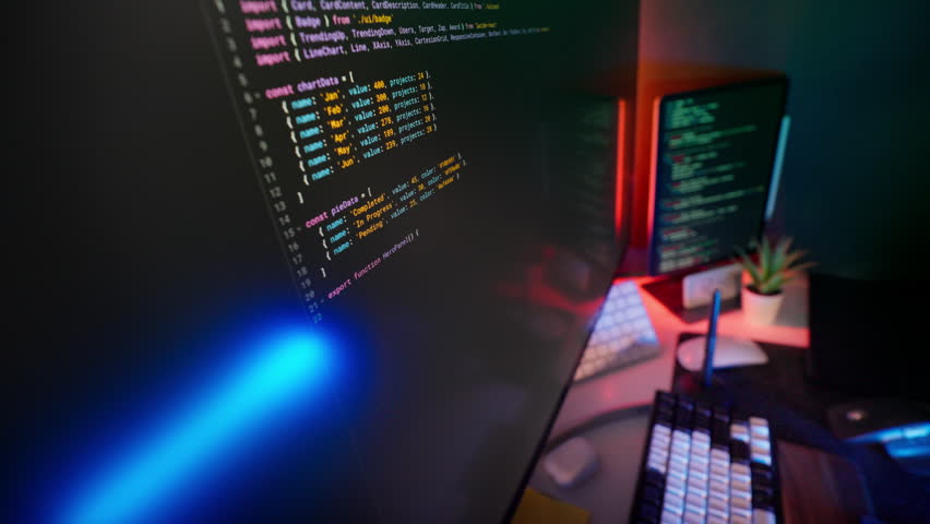 Programming Code Lines IT support Modern Studio computer equipment security environment with multiple glowing screens, keyboards and colorful ambient lights. Concept of digital support, development ex
