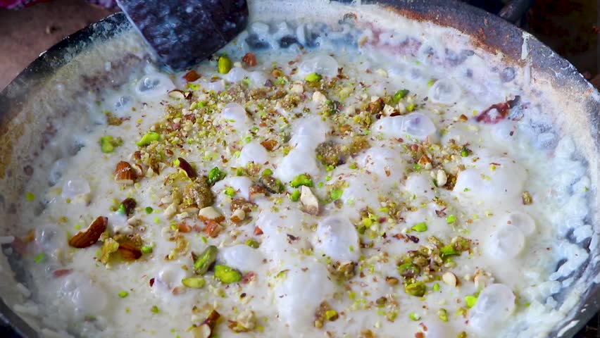 Kheer Making – Traditional Indian Rice Pudding,
Kheer making, the traditional Indian rice pudding dessert, showing the creamy milk base and nuts being added. Perfect for cooking tutorials, recipe blog