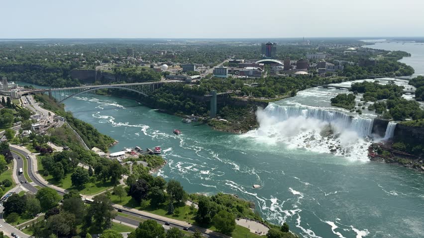 The American Falls and Bridal Veil Falls, the U.S. Customs and Border Protection – Rainbow Bridge Port of Entry, and the Prospect Point Observation Tower in Niagara Falls, Ontario, Canada.