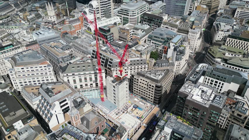 A construction site dominated by cranes, emphasizing growth and the evolution of the urban landscape in modern cities in London, UK. City of London.