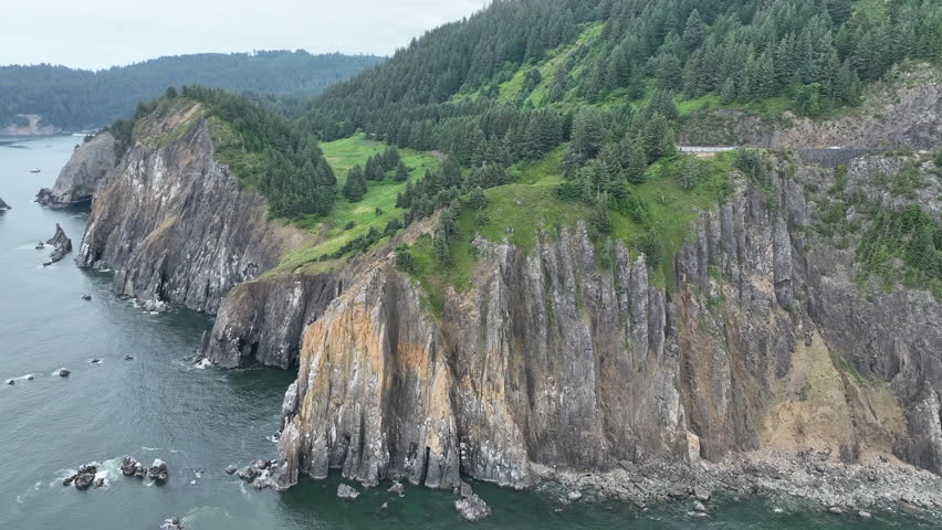 The Pacific Ocean washes against the rugged, rocky shoreline of northern Oregon, just south of Cannon Beach. This part of the Pacific Northwest has incredibly scenic coastlines and beaches.